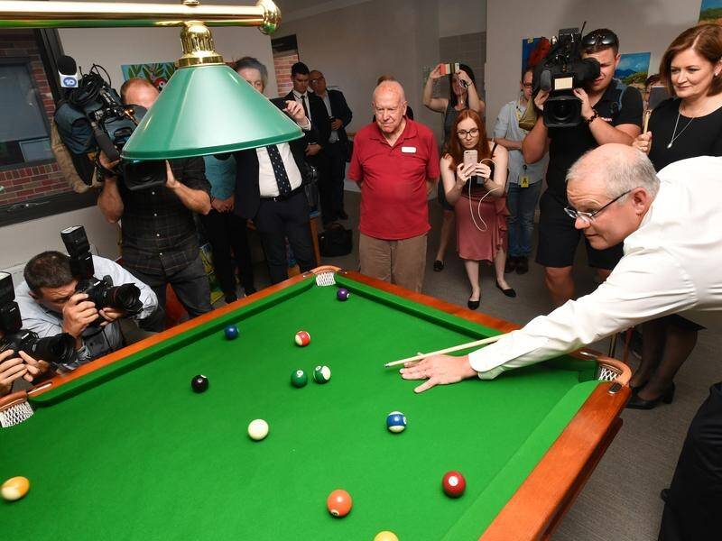 Prime Minister Scott Morrison tries out his pool and people skills at a Geelong aged care facility.