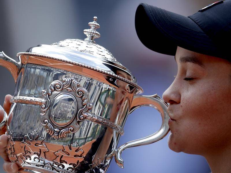 World No.1 Ashleigh Barty poses with the French Open trophy she won at Roland Garros.