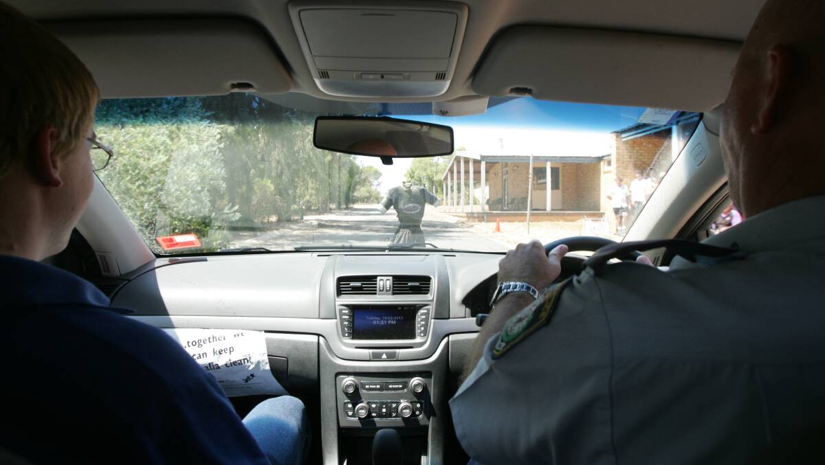 CONSTABLE Andrew McKelvie (right) demonstrates to Yanco Agricultural High School student Tom Schlunke stopping at high speeds when a "person" is standing on the road. 

