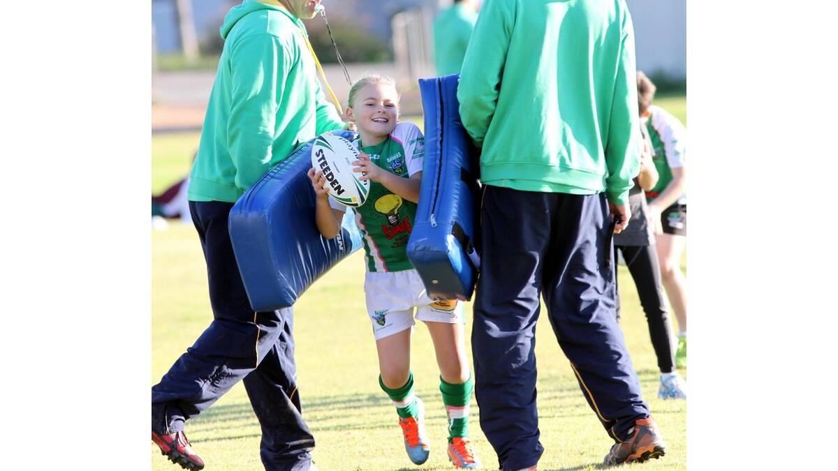 HAYLEY Bull bursts through the tackle pads and into another skills activity at the rugby league junior development clinics held last Thursday.
