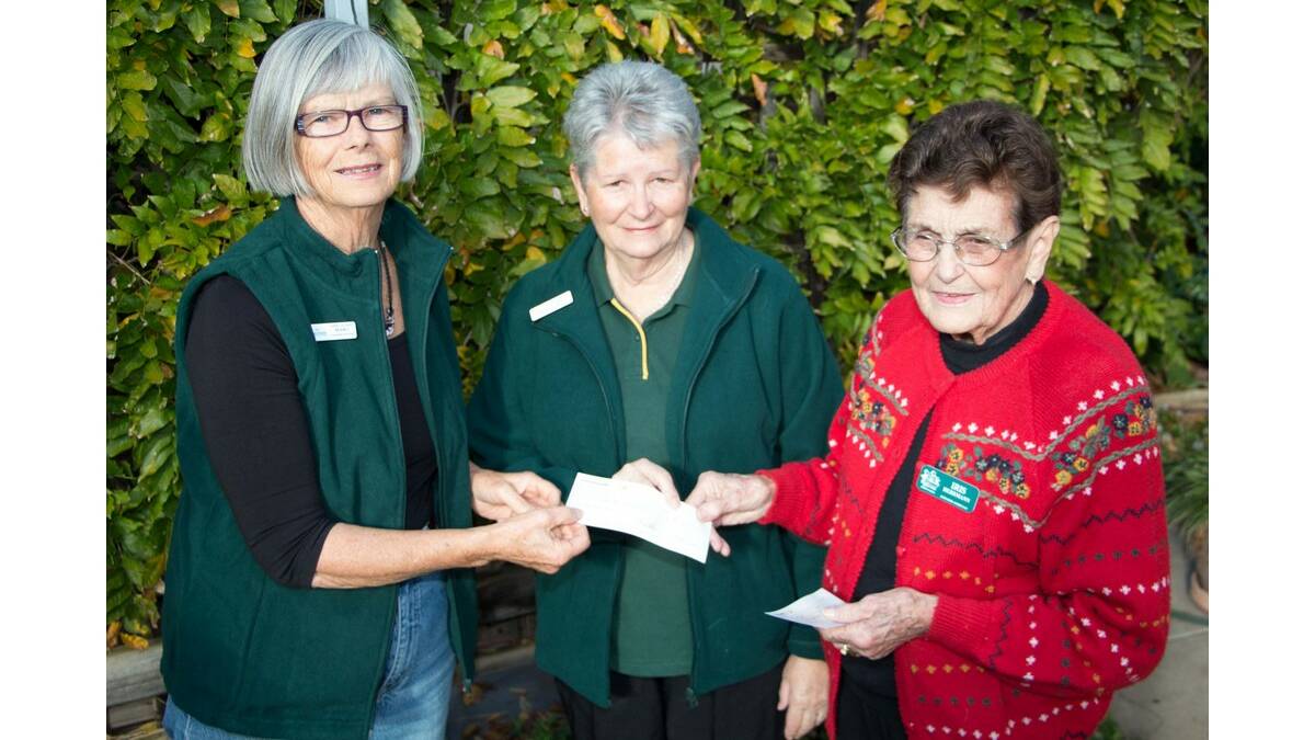 WATER Wheel Garden Club president Iris Herrmann (right) presents cheques to the Marg Baulch (left) and Sue Johnson from Can Assist.