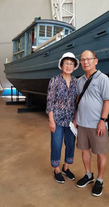 My parents at the NT Museum with a boat just like the one we left Vietnam on more than 40 years ago. Picture: Supplied