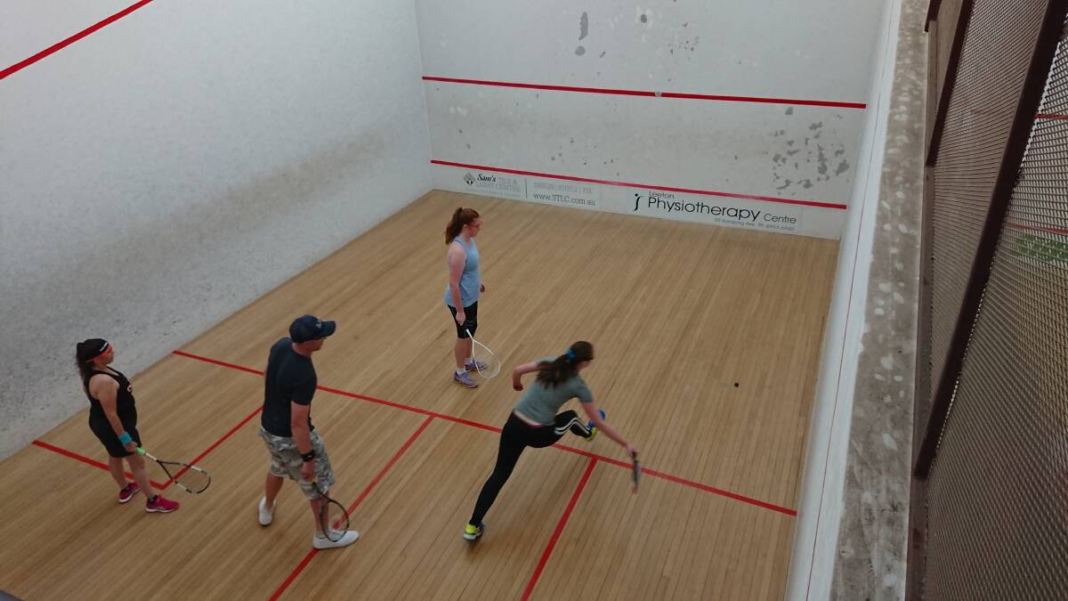 FUN: Marnah Cunningham reaches to play a forehand while (from left) Naomi Rawle, Michael McColl and Katie McAliece watch on.