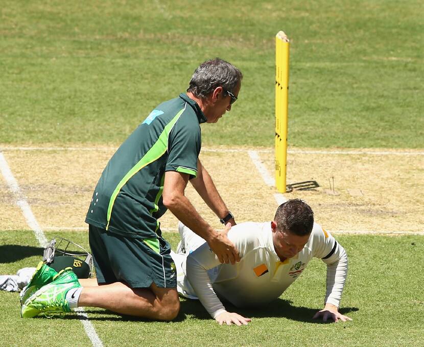 Team doctor Peter Brukner checks batter Michael Clarke during the First Test between Australia and India at Adelaide Oval in 2014. Picture: Getty Images