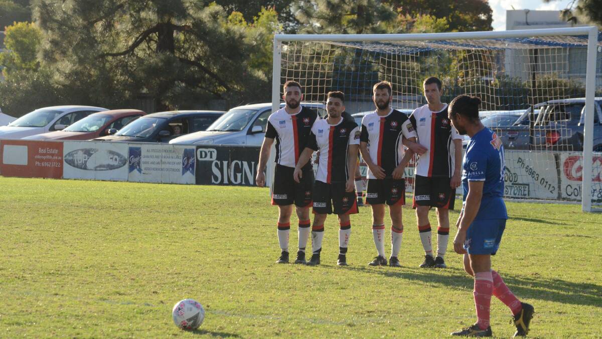 WALLED OFF: Leeton United prepare to defend a penalty kick during their match against Hanwood.