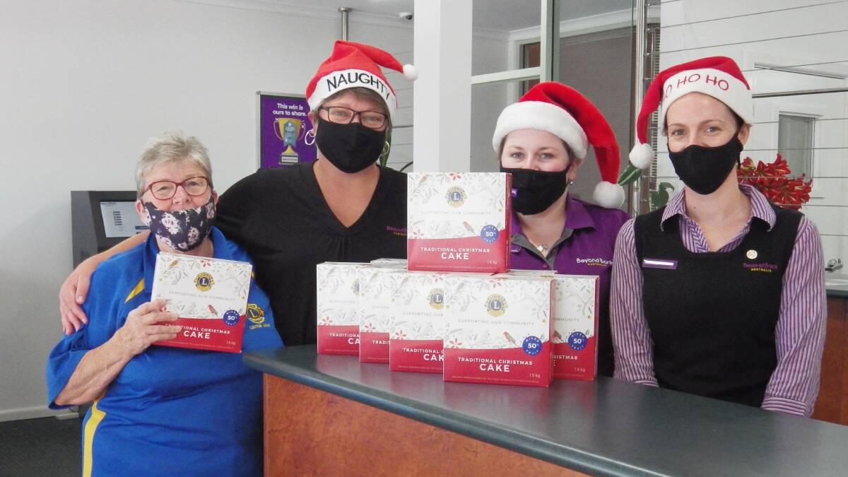 CAKE TIME: Lions president Marie Jackson with Beyond Bank Leeton staff Amber McKenzie, Eliza Smith and Ashleigh Melzer. PHOTO: Supplied