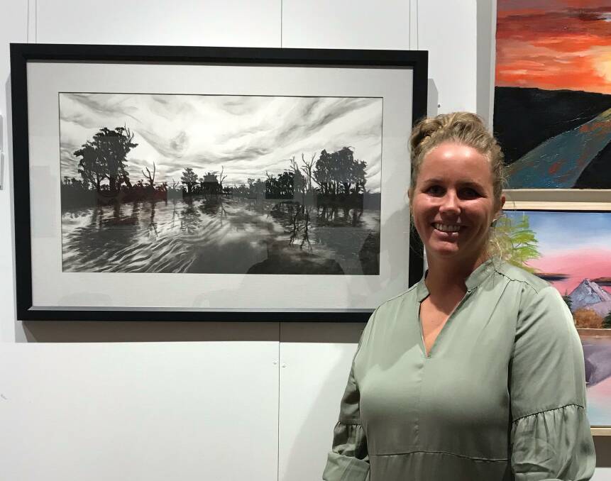 WINNER: Ayla Young with her artwork 'Sunset at Bundidgerry Creek', which won the Acquisitive Prize in the Penny Paniz Art Competition. PHOTO: Leeton Art Society