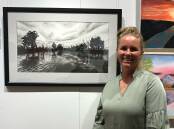 WINNER: Ayla Young with her artwork 'Sunset at Bundidgerry Creek', which won the Acquisitive Prize in the Penny Paniz Art Competition. PHOTO: Leeton Art Society