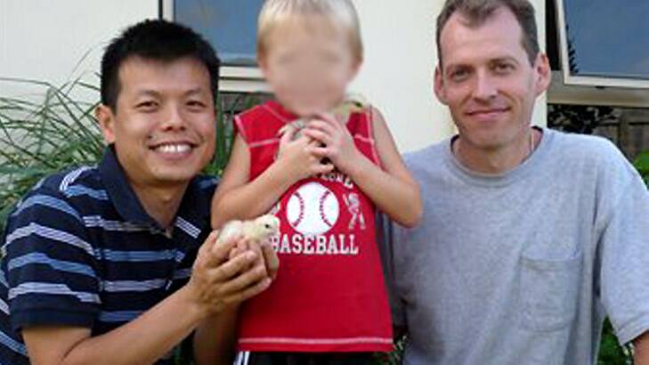 Newton, right, with Truong and their son outside their Cairns home.
