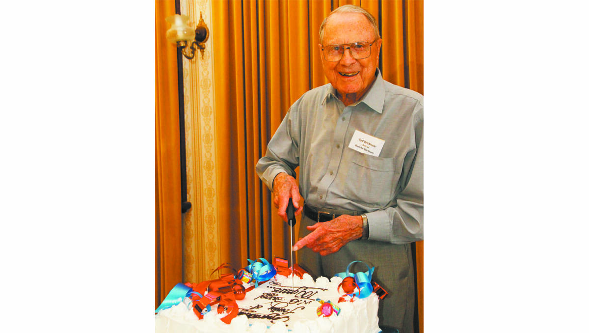 SYD Wickham, 97, cuts the cake at the Gavel family reunion.