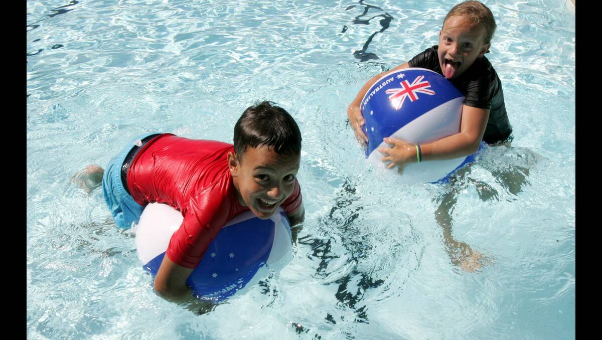 SAMUEL, 9, and Isabella Polimeni, 7, have fun with the Australia Day beachballs at Leeton pool.
