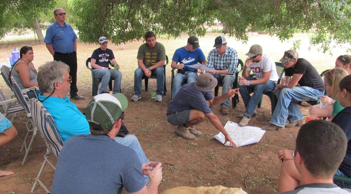 GOGELDRIE farmer Garry Knagge (centre) discusses plans on his farm for crops, livestock and tree belts with the Western Illinois University students.