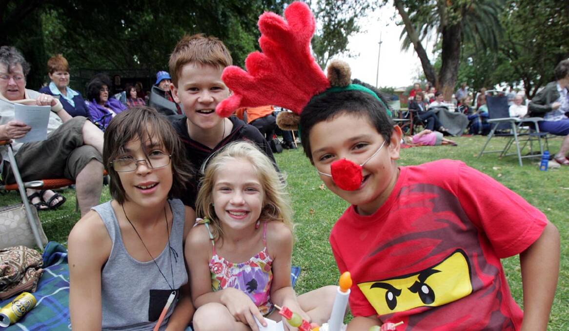 CAROLS in the Park has many in the festive spirit, including (from left) Nick Puntoriero, 11, Patrick Draper, 11, Sarah Puntoriero, 8, and Remy Pages, 8.