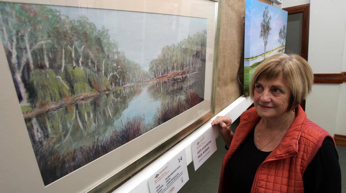 THE inaugural winner of the Penny Paniz Arts Acquisitive Competition Lynne McQuillan with her work titled Murrumbidgee River.
