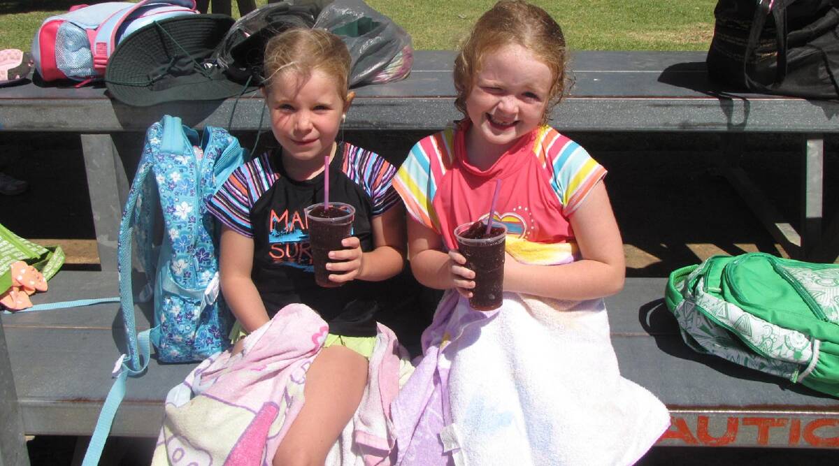 Breea Ison (7) and Isabel Harris (7) cool down poolside at the Parkview PS Carnival held last Friday at the Leeton Pool.